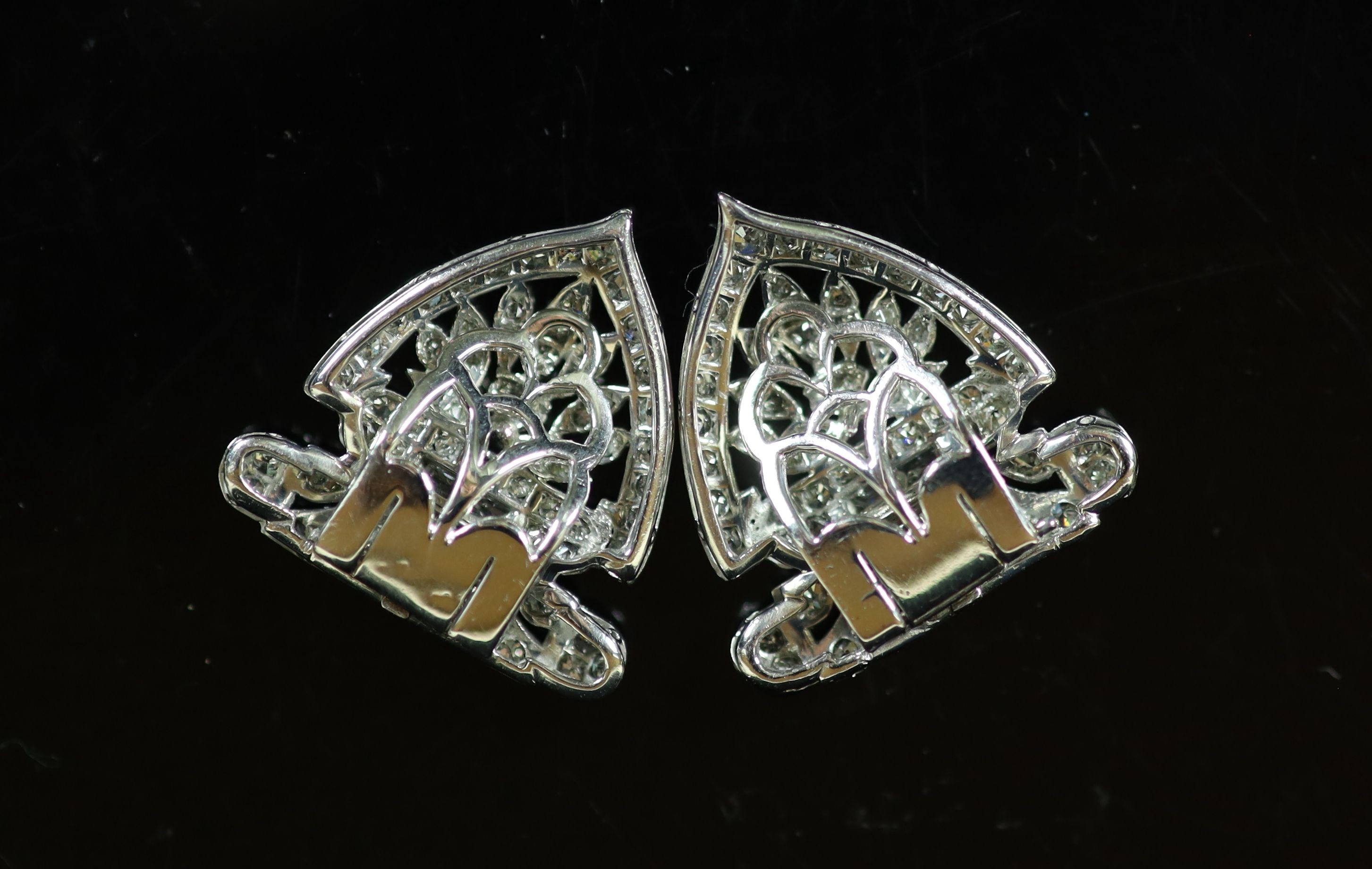 A pair of 1960's pierced platinum and diamond fan shaped ear clips